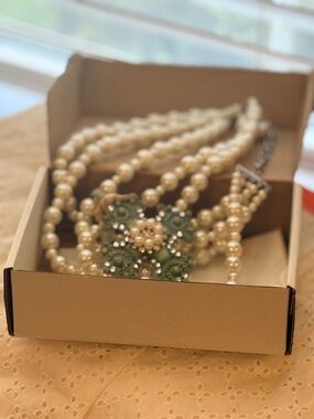 A Rare Bird Multi-Strand Pearl Necklace with Green Crystal Floral Accent